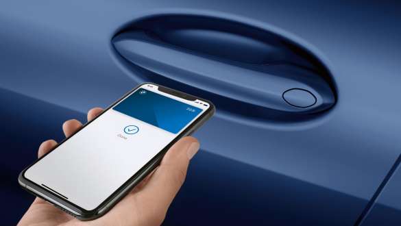 Digital Key The New BMW 8 Series Convertible G14 LCI Facelift 2022 Hand holding smartphone in front of car door Digital Key The New BMW 8 Series Convertible G14 LCI Facelift 2022 close-up