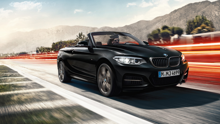 BMW 2 Series Convertible F23 three-quarter front view driving on the street BMW 2 Series BMW 2 Series Convertible F23 three-quarter front view driving on the street