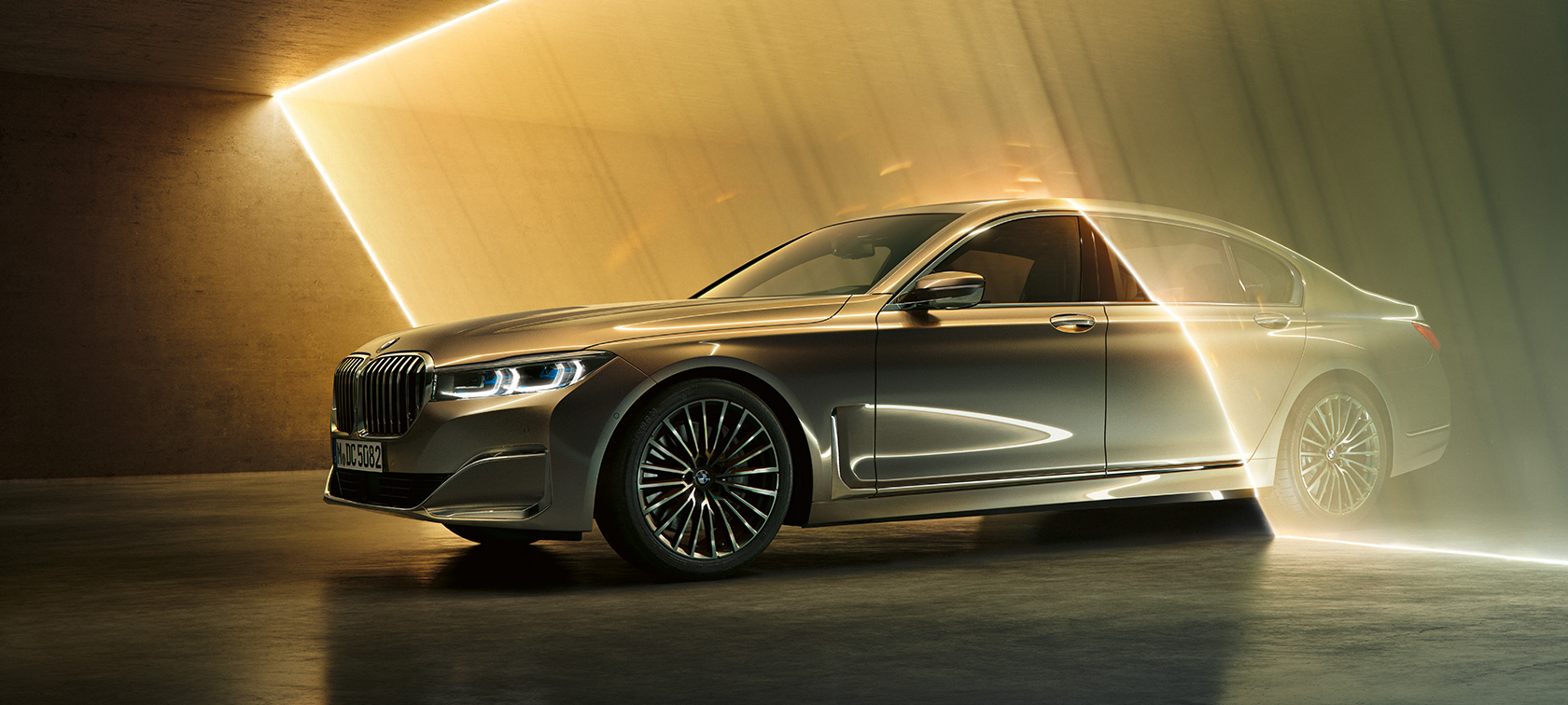 BMW 7 Series Sedan in three-quarter front view BMW 7 Series Sedan G11 G12 2019 Bernina Grey Amber Effect three-quarter front view surrounded by beams of light