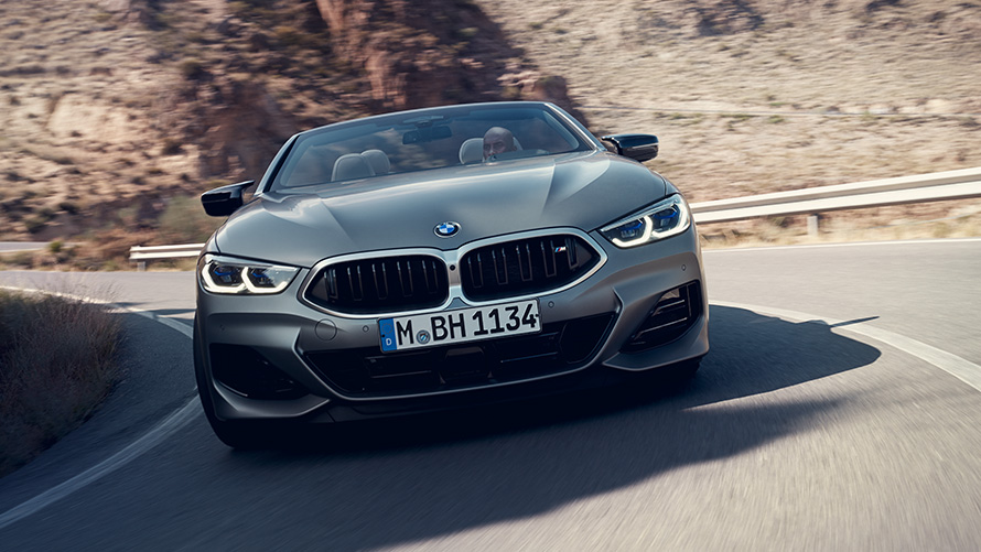 The New BMW 8 Series Convertible M sport package G14 LCI Facelift 2022 front view driving through corner The New BMW 8 Series Convertible M sport package G14 LCI Facelift 2022 BMW Individual Frozen Pure Grey metallic front view driving through corner