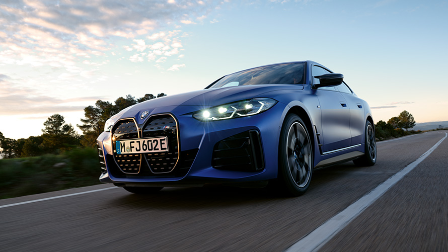 BMW i4 M50 G26 2021 BMW Individual Frozen Portimao Blue metallic three-quarter front view driving low angle shot