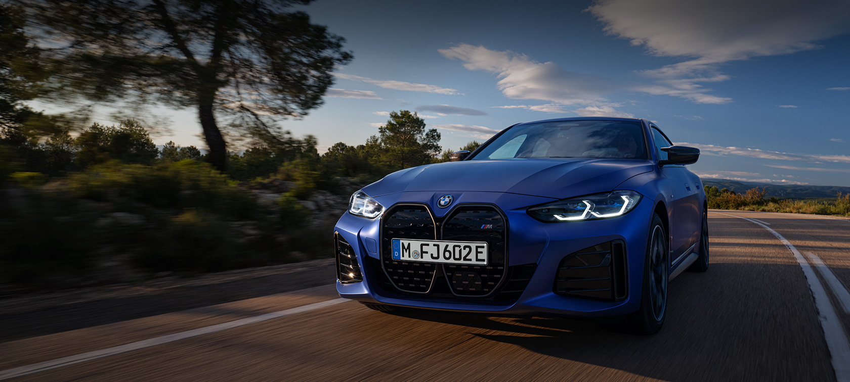 BMW i4 M50 G26 2021 BMW Individual Frozen Portimao Blue metallic three-quarter front view driving