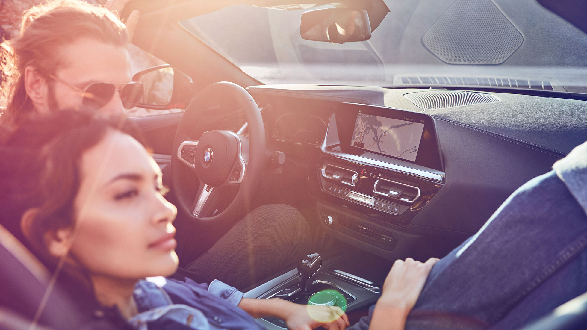 Dark-haired woman and man in BMW Z4 Roadster Lorem Ipsum