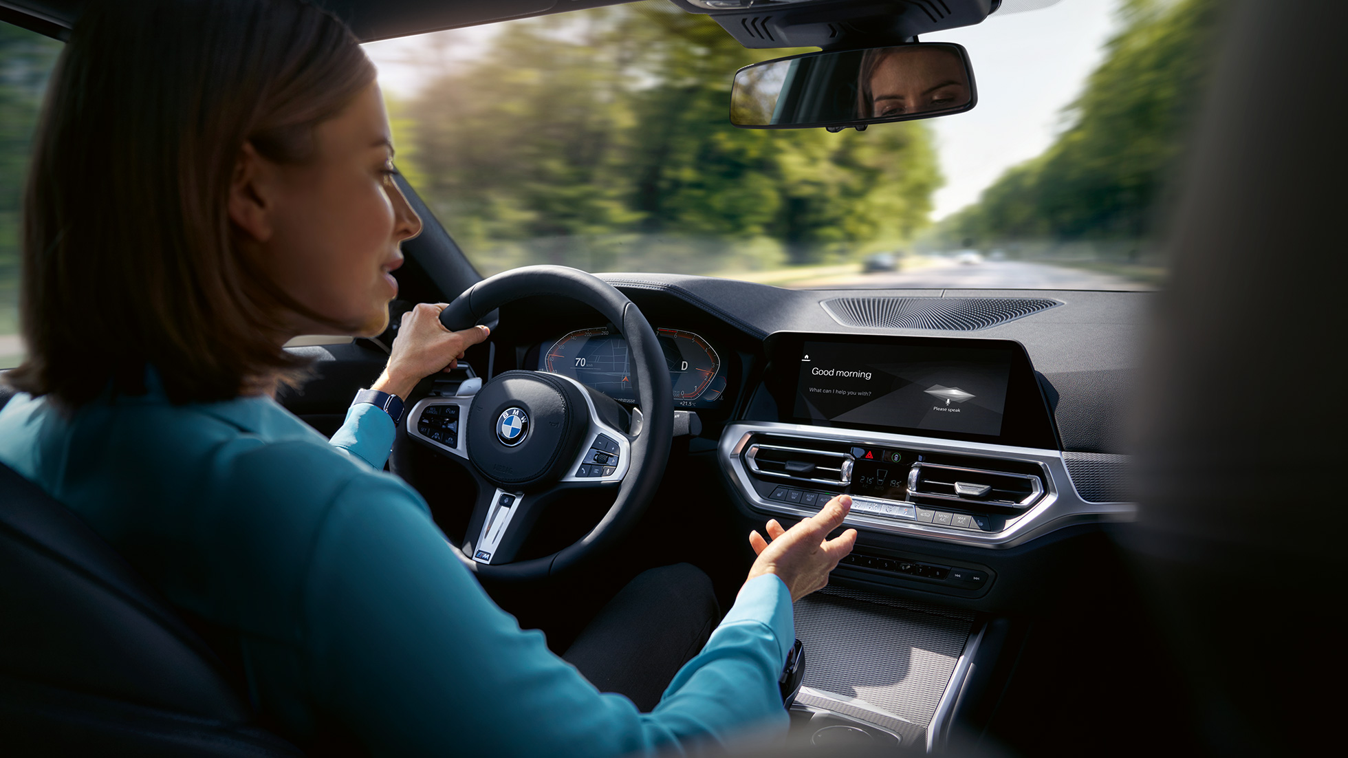 Woman using Intelligent Personal Assistant in her BMW Woman using BMW ConnectedDrive Intelligent Personal Assistant in her BMW