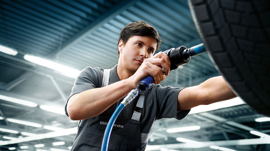 BMW wheels service BMW wheels service: BMW service employee repairing a BMW